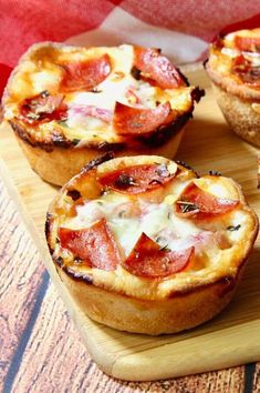 mini pizzas with cheese and pepperoni on a cutting board