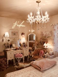 a bedroom with a chandelier, bed and dressers in front of it