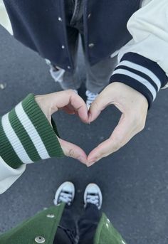 two people making a heart with their hands