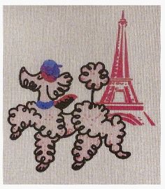 a cross stitch picture of a poodle in front of the eiffel tower