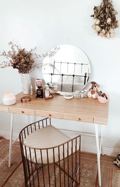 a wooden desk topped with a round mirror