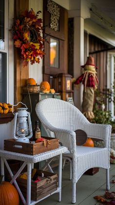 a porch decorated for fall with pumpkins and other decorations