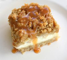 a piece of cheesecake on a plate with caramel sauce