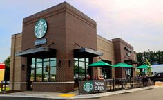 a starbucks coffee shop with green umbrellas outside