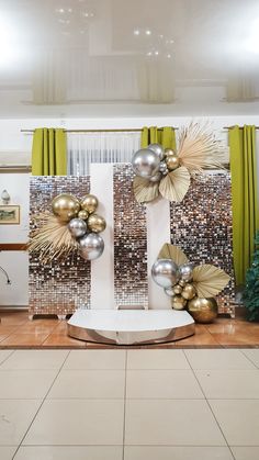 a room decorated with gold and silver balloons