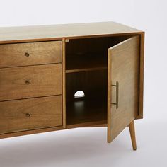 a wooden cabinet with three drawers and one door open