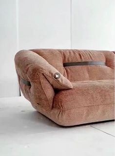 a brown chair sitting on top of a white floor