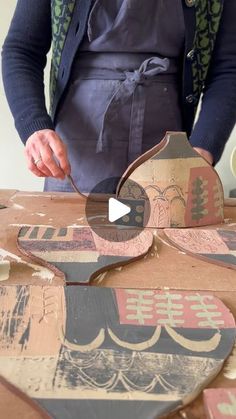 a person standing over a table with some skateboards on it