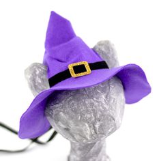 a purple hat with a gold buckle is on top of a gray headpieces