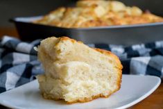 a close up of a piece of cake on a plate with a pan in the background