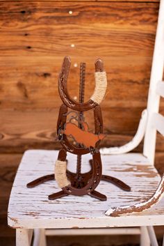 a wooden chair with a horse saddle on it