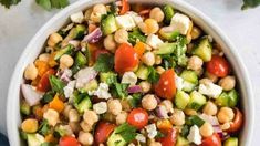 a salad with chickpeas, tomatoes, cucumbers and feta cheese