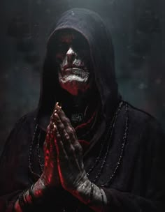 a person in a black hoodie with red paint on their face and hands, praying