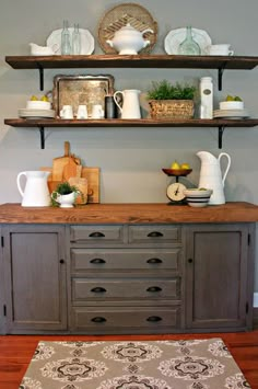 an old dresser is decorated with dishes and vases on it's top shelf