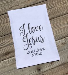 a tea towel with the words i love jesus but i drink a little on it