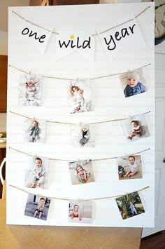 a white board with pictures hanging from it's sides that says one wild year