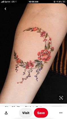 a woman's arm with a flowered crescent tattoo on the left side of her arm