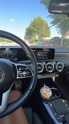 the interior of a car with steering wheel and dashboard