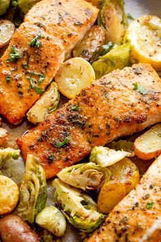 salmon, potatoes and brussel sprouts in a pan with lemons