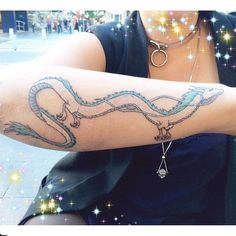 a woman with a snake tattoo on her arm