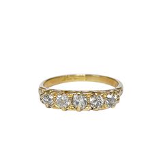 a yellow gold ring with five diamonds