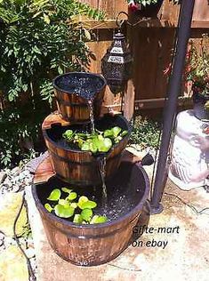 a wooden barrel filled with water and plants