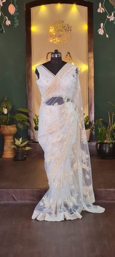 A unique piece , simple, elegant and beautiful. saree fabric:soft net with embroidery  length:5.5 meters blouse: net fabric ( same as saree) NOTE: blouse on the mannequin is for display purposes. Blouse fabric is same as saree. Size: please choose a standard size from the drop down or you can choose custom measurements.  I'll send you a detailed measurements chart once you order. Saree Mannequin Display, Designer Pre-draped Off White Saree With Sheer Dupatta, Festive White Organza Pre-draped Saree, Semi-stitched White Organza Saree, Cream Saree Blouse Piece With Sheer Dupatta, Bollywood Style Wedding Pre-draped Saree With Lace Work, Festive Off White Organza Saree, Festive Off-white Organza Saree, Semi-stitched Lace Work Pre-draped Saree For Wedding