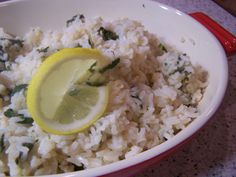 rice with lemon and spinach in a red bowl on a counter top, ready to be eaten