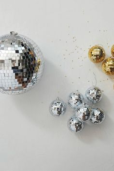 disco balls and ornaments on a white surface