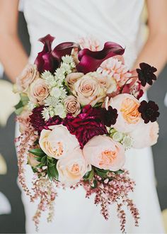 a bride holding a bouquet of flowers in her hands