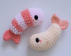 two crocheted toy fish sitting next to each other