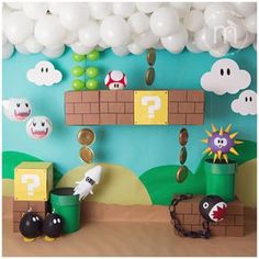 a super mario birthday party with balloons and decorations on the wall, including paper mario's house