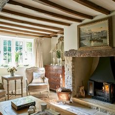 a living room filled with furniture and a fire place in front of a painting on the wall