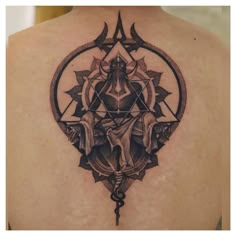 the back of a woman's shoulder with an intricate tattoo design on her upper