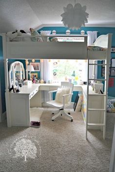 a bedroom with a bunk bed and desk in it's corner, surrounded by blue walls