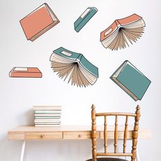 books flying in the air on top of a table next to a chair and desk