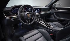 the interior of a sports car with black leather seats and gauges, steering wheel and dash board