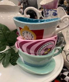 stack of tea cups with clocks on them