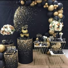 a black and gold party with balloons, confetti and cake on the table