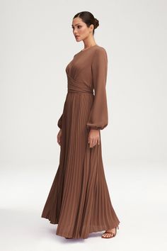 Introducing the Layana Pleated Wrap Waist Maxi Dress in Pecan. Indulge in the luxurious pleated skirt and balloon sleeves, creating a sophisticated and exclusive look. The wrap waist adds a touch of femininity, making this dress perfect for any occasion. Model is 5'7" and is wearing size XS/58". Veiled Collection, Pleated Dresses, Groom Dresses, Fall Weddings, Groom Dress, Mother Of The Groom, Balloon Sleeves, Beautiful Gift Boxes, Pleated Dress