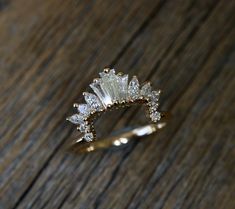 a diamond ring sitting on top of a wooden table