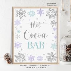 a sign that says hot cocoa bar next to some pine cones and snowflakes