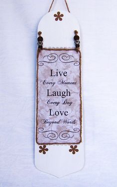 a sign hanging on the wall that says live every moment laugh every day love beyond words