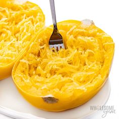 a fork is being used to cut the inside of a spaghetti dish with cheese on it