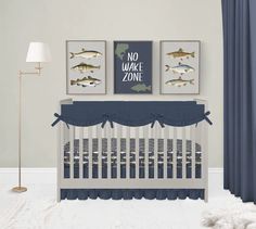 a baby's room with two pictures on the wall and a crib bed