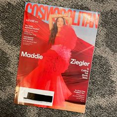 a magazine with a woman in a red dress on the cover