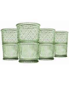 four green glass tumblers sitting next to each other