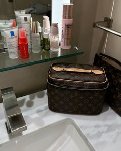 a vanity with some personal care items on it and a mirror in the back ground