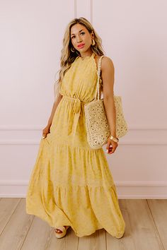 You are sure to feel nothing but happiness when you dress to impress in this beautiful primrose yellow colored maxi featuring lightweight flowy material patterned with a subtle floral print, a high neckline with a halter tie closure, ruffled trim detailing, a cinched waistline with a tie belt, and a relaxed tiered skirt silhouette that cascades into a straight ankle-length hemline! Measurements S : Bust 30", Hip 38", Length 54", Waist 26-28". M : Bust 32", Hip 40", Length 54", Waist 28-30". L : Spring Yellow Halter Dress For Beach, Yellow Halter Dress For Spring Beach Outing, Yellow Floral Print Halter Neck Maxi Dress, Yellow Halter Dress For Beach Spring Season, Yellow Halter Dress For Spring Vacation, Yellow Halter Dress For Spring Beach, Yellow Halter Dress For Spring Beach Occasion, Yellow Halter Neck Maxi Dress For Spring, Chic Yellow Halter Neck Maxi Dress