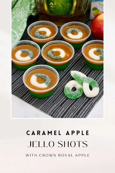 caramel apple jello shots with crown royal apple on the side and green apples in the background